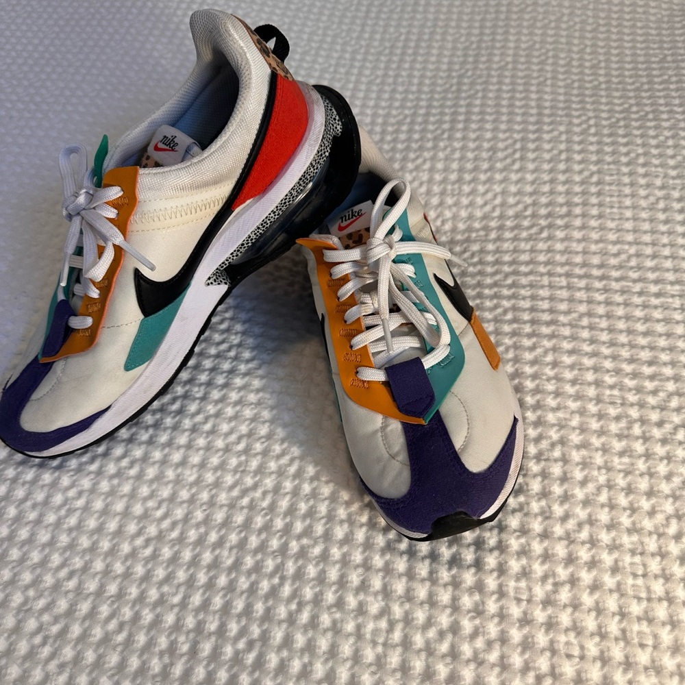 Nike White Sneakers with Black Insole and Red Swoosh Accent